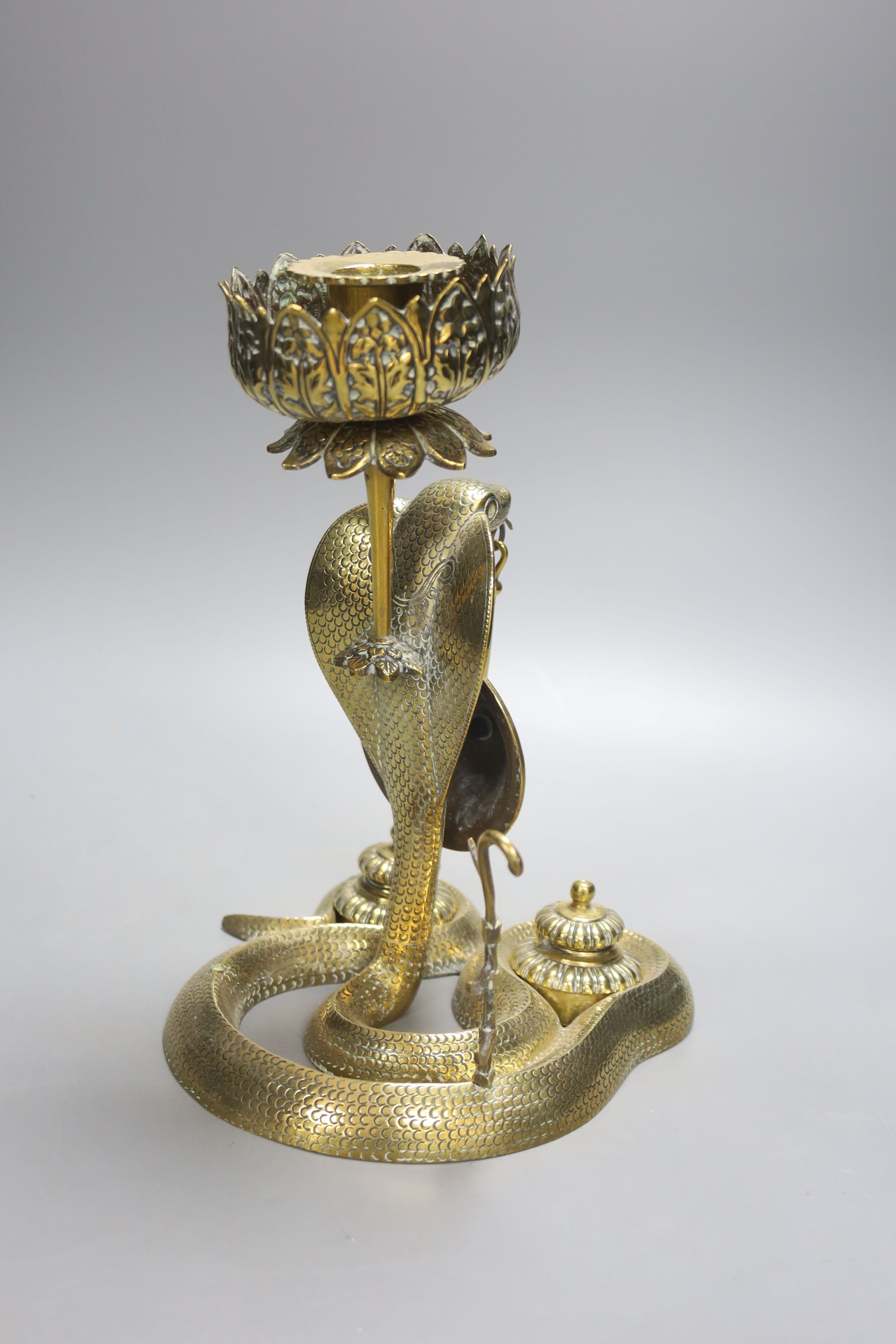 An Indian brass ‘cobra’ desk stand, 26 cms high.
